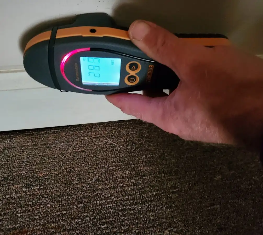 Moisture detection at baseboard during Storm Damage Restoration in St. Andrews